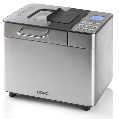 Machine à pain Domo B3971 en acier inoxydable brossé de trois quarts, hublot et trappe du distributeur sur le couvercle, bandeau LCD à droite